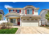 Charming two-story home featuring red shutters, a well-maintained lawn, and a spacious two car garage at 5570 Perth Ct, Denver, CO 80249