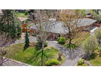 Aerial view of ranch-style home featuring mature landscaping, a circular driveway, and a well-maintained yard at 5471 S Sherman St, Littleton, CO 80121