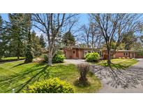 Charming single-story brick home with a well-maintained lawn and mature trees in a desirable neighborhood at 5471 S Sherman St, Littleton, CO 80121
