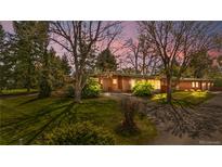 Charming brick ranch-style home with a well-manicured lawn and mature trees, offering great curb appeal at 5471 S Sherman St, Littleton, CO 80121
