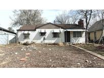 Charming single-story home featuring a cozy front yard with awning-covered windows, and classic architectural details at 4330 Zenobia St, Denver, CO 80212