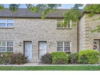 Charming townhome featuring light brick, mature landscaping, and a welcoming entrance at 5511 S Lowell Blvd, Littleton, CO 80123