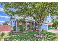 Charming blue home with brick accents, a well-maintained lawn, and mature shade tree at 433 N 15Th Ave, Brighton, CO 80601