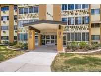 Inviting entrance with glass doors and prominent address signage, surrounded by landscaped greenery at 9655 E Center Ave # 11D, Denver, CO 80247