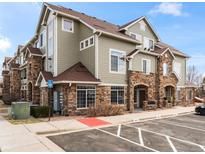 Attractive condo building with stone accents, light green siding, and accessible parking at 12711 Colorado Blvd # 101A, Thornton, CO 80241