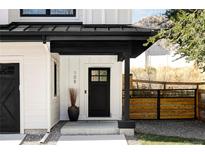 Modern farmhouse front door with black trim, white siding, and complementary landscaping at 108 Arapahoe St, Golden, CO 80403