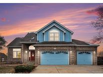 Charming two-story home with brick accents, blue siding, and a three-car garage at 18715 Wagon Trl, Mead, CO 80542