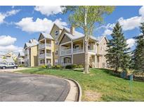 Inviting multi-story condo with a private porch, landscaped lawn and sidewalks at 6013 Castlegate W Dr # D14, Castle Rock, CO 80108