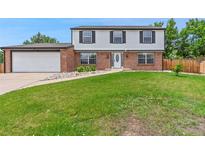 Charming two-story home with a well-manicured lawn and inviting curb appeal at 9451 W Hialeah Pl, Littleton, CO 80123