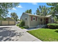 Charming single-Gathering home with a lush green lawn, private yard and detached garage at 4546 S Logan St, Englewood, CO 80113