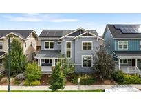 Two-story craftsman style home with solar panels and landscaped yard at 5524 Uinta St, Denver, CO 80238