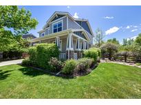 Inviting two-story home featuring manicured landscaping and a charming covered porch at 902 Jarvis Dr, Erie, CO 80516