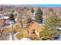Lovely aerial view of a backyard deck on a property with mature landscaping and mountain views at 12286 W Tennessee Ave, Lakewood, CO 80228