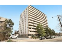 High-rise apartment building with multiple balconies and surrounding trees at 1029 E 8Th Ave # 901, Denver, CO 80218