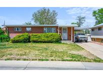 Charming single-story brick home with a covered parking area and well-maintained front yard at 245 S 13Th Ave, Brighton, CO 80601