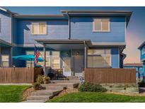 Charming two-story townhome with a covered porch and fenced yard at 12022 Locust St, Brighton, CO 80602