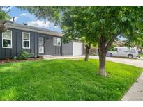 Charming single-story home featuring a well-manicured lawn, brick facade, attached garage and mature landscaping at 5170 Deephaven Ct, Denver, CO 80239