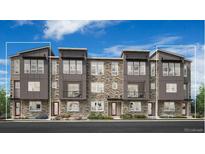 Modern townhome exterior featuring stone accents, dark trim, large windows, and inviting entrance doors at 6295 N Kirk St, Aurora, CO 80019