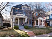 Charming two-story home featuring a welcoming front porch and well-maintained landscaping at 713 S Washington St, Denver, CO 80209