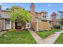 Charming townhome with a brick chimney and a well-maintained front yard at 14231 E Dickinson Dr # E, Aurora, CO 80014
