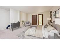 Comfortable main bedroom featuring a spacious layout, gray dresser, chair, and ensuite bathroom access at 14231 E Dickinson Dr # E, Aurora, CO 80014