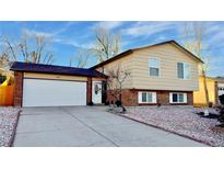 Brick ranch home with attached garage and landscaped yard at 2683 S Carson Way, Aurora, CO 80014