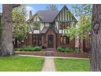 Charming Tudor-style home with brick facade, landscaped front yard, and inviting entrance at 536 N Williams St, Denver, CO 80218