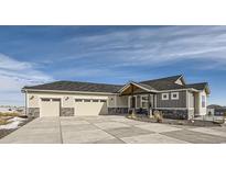Beautiful ranch home with three-car garage, stone accents, and landscaped entry at 229 High Meadows Loop, Elizabeth, CO 80107
