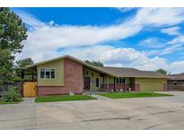 Brick ranch home with attached garage and spacious yard at 14121 Countryhills Dr, Brighton, CO 80601