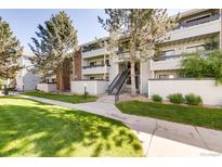 Multi-level condos featuring well-maintained lawns, mature trees and private balconies at 14206 E 1St Dr # B10, Aurora, CO 80011