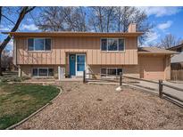 Charming two-story home with a blue door, well-maintained landscaping, and a cozy, inviting appeal at 1529 Ashcroft Dr, Longmont, CO 80501