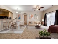 Open living room and dining area with patio access at 5255 Memphis St # 917, Denver, CO 80239