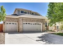 Charming two-story home featuring a three-car garage and well-maintained front yard at 20394 E Colgate Pl, Aurora, CO 80013