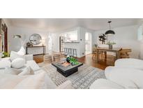 Bright living room featuring modern furniture, hardwood floors, and an open floor plan to the kitchen at 2090 Irving St, Denver, CO 80211