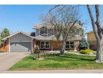 Charming two-story home with brick and siding, attached garage, and well-maintained lawn at 1430 S Lima St, Aurora, CO 80012