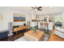 Bright living room with open kitchen, hardwood floors, stylish furnishings, and modern decor at 2408 Irving St, Denver, CO 80211