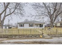 Ranch style home with wood fence and landscaping at 1840 Rowena St, Thornton, CO 80229