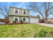 Charming two-story home featuring a well-maintained front lawn, a two car garage and classic curb appeal at 10645 Moore Ct, Broomfield, CO 80020