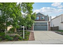 Charming two-story home with a well-manicured lawn and a spacious two-car garage at 6307 Monterey Pl, Highlands Ranch, CO 80130