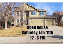 Two-story house with a large driveway and landscaped yard at 13262 Pennsylvania St, Thornton, CO 80241