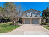 Charming two-story home with a two-car garage, landscaping, and inviting curb appeal on a sunny day at 7586 S Detroit St, Centennial, CO 80122