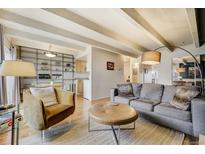 Inviting living room featuring hardwood floors, a comfortable sofa, unique furniture, and bright, open layout at 200 N Pearl St # 404, Denver, CO 80203