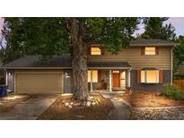 Charming two-story home featuring brick accents, mature trees, and a welcoming entrance at 2730 S Jay St, Denver, CO 80227