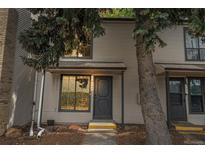 Inviting townhome with neutral siding and ample natural light streaming through large windows at 3550 S Harlan St # 105, Denver, CO 80235