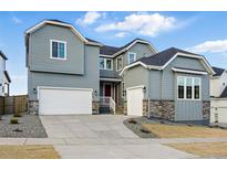 Beautiful two-story home featuring a three-car garage and well-maintained landscaping at 16549 Black Rose Cir, Parker, CO 80134