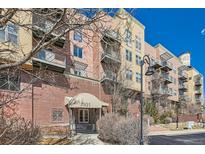 View of the attractive brick apartment building entrance and awning with the building number 7931 at 7931 W 55Th Ave # 217, Arvada, CO 80002