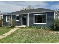 Charming single story home with new gray horizontal siding, white trim, and a well-manicured front yard at 1100 N Hanover St, Aurora, CO 80010