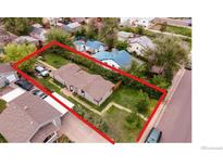 An aerial view of a single-story home showcasing its compact layout and a yard enclosed by a tall hedge at 2258 S Galapago St, Denver, CO 80223