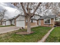 Charming single-Gathering home with brick accents, a well-manicured lawn, and an attached two-car garage at 45 Pierce St, Lakewood, CO 80226