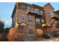 Attractive three-story townhome with stone accents and a balcony at 18766 E Yale Cir # A, Aurora, CO 80013